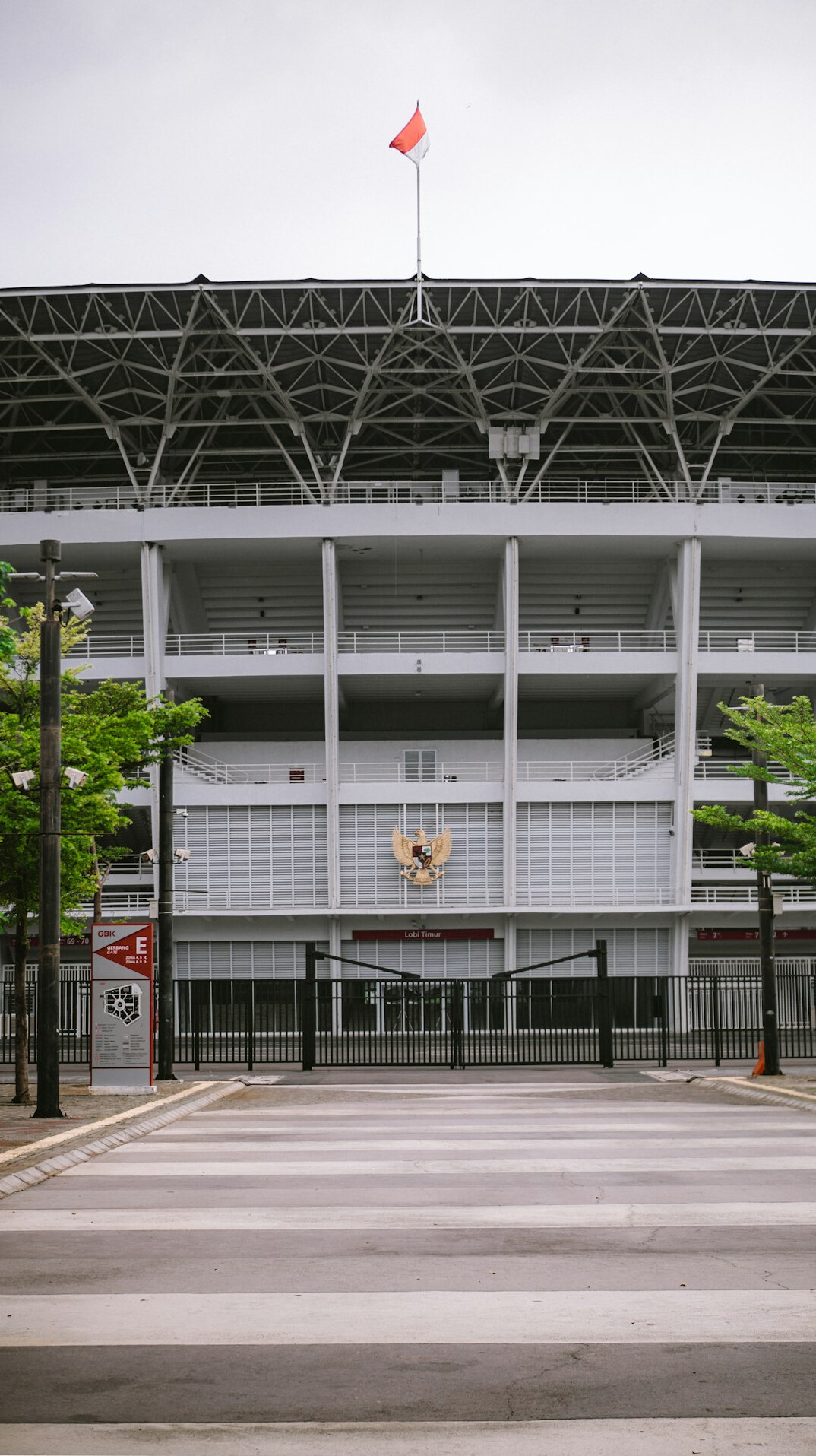 Outside broadcast van with satellite dish parked outside a stadium